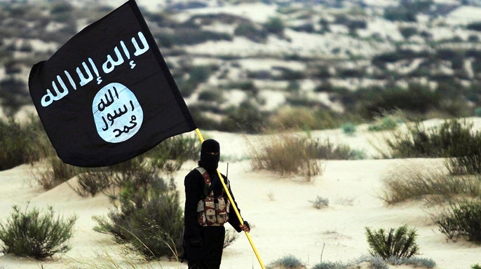 soldier-holds-isis-flag.jpg