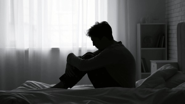 silhouette-depressed-young-man-sitting-600nw-2559082899.jpg